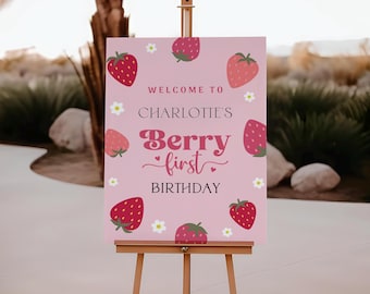 Könnte beinhalten: Rosa Willkommens-Schild mit Erdbeer-Motiv. Das Schild lautet "Willkommen zu Charlotte's Berry First Birthday".
