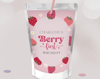 May include: A pink juice pouch with a strawberry design. The text "Charlotte's Berry First Birthday" is displayed in a circular design. Strawberries and white flowers decorate the pouch, and a pink straw is inserted.