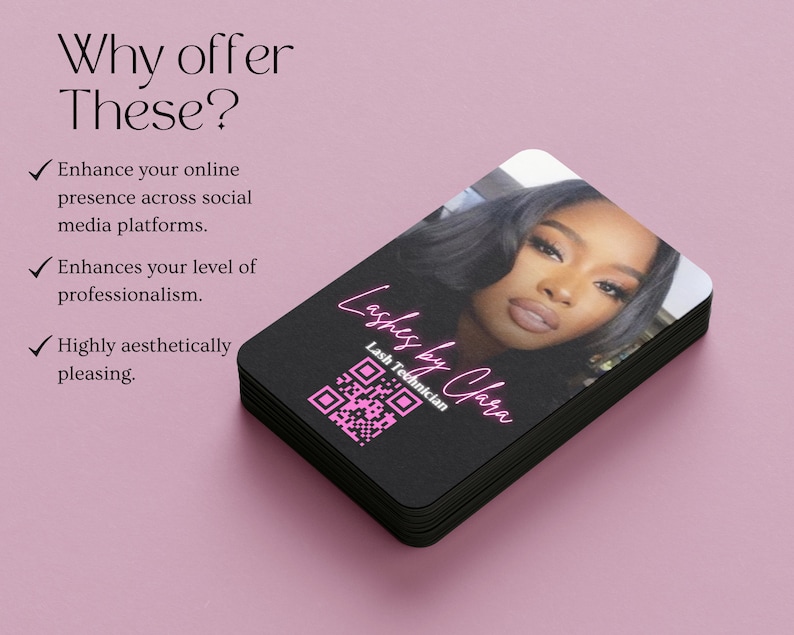 May include: A stack of black business cards with a pink and white design. The top card features a photo of a woman with a QR code and the text "Lashes by Clara" and "Lash Technician".