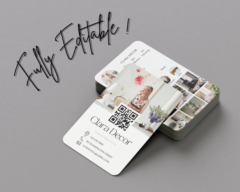 May include: A white business card with rounded corners featuring a QR code, a woman's photo, and the text "Clara Decor Interior Decorator" with contact information.