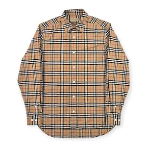 May include: A long-sleeved button-down shirt in a tan, black, red, and white plaid pattern. The shirt has a classic collar and buttoned cuffs. The brand name is visible on the collar.