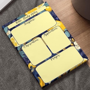 May include: A yellow and blue notepad with a floral design. The notepad is divided into four sections labeled "Scripture", "Observation", "Application", and "Prayer".