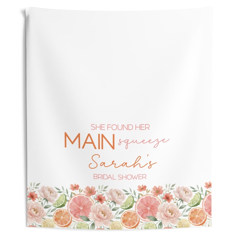 May include: White bridal shower towel with a floral border featuring pink grapefruit slices, orange slices, and green limes. The towel has the text "SHE FOUND HER MAIN squeeze Sarah's BRIDAL SHOWER" in orange and pink.