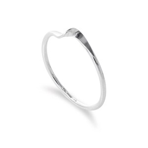 May include: A silver ring with a curved, wave-like design. The ring is thin and delicate, with a smooth, polished finish. The ring is set against a white background.