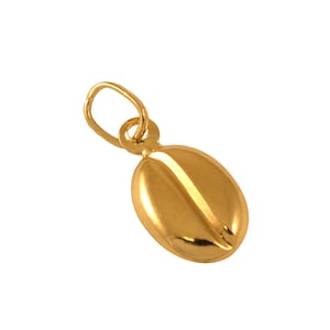 May include: A polished gold pendant shaped like a coffee bean, featuring a smooth, rounded surface with a central vertical groove and a small circular jump ring attached at the top for hanging on a chain or cord, presented against a plain background.