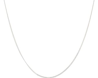 May include: A silver chain necklace with a fine curb link design. The necklace is shown against a white backdrop, emphasising its simple elegance. A classic piece of jewellery.