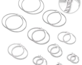 May include: A collection of silver hoop earrings in various sizes. The earrings have a textured, diamond-cut design. The image shows multiple pairs of earrings, some with a smooth finish and others with a textured surface. The earrings are displayed on a white background.