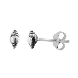 May include: A pair of silver-colored seashell stud earrings. The earrings are small, with a detailed conch shell design. One earring is fully visible, while the other is partially visible. The earrings have a post and butterfly backing.