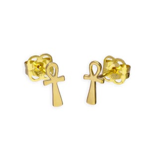 May include: A pair of gold-colored ankh stud earrings. Each earring features the ankh symbol, a looped cross, on a post with a butterfly clutch. The earrings are displayed against a white background.