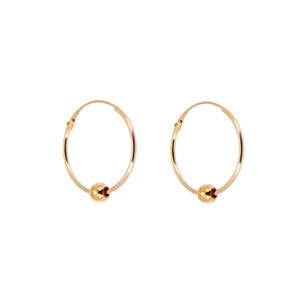 May include: Two gold-colored hoop earrings with a small, round bead at the bottom of each hoop. The earrings are set against a white background, highlighting their simple design and metallic sheen. The hoops are circular and have a polished finish.