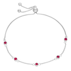 May include: A silver bolo bracelet with five round, bright red gemstones. The bracelet has a delicate chain design and a sliding bead closure for adjustable sizing. The gemstones are evenly spaced along the chain.