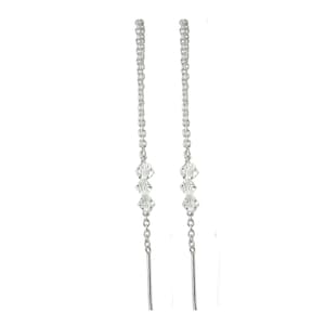 May include: A pair of silver-toned threader earrings featuring a delicate chain design. Each earring is accented with three small, clear, faceted crystal beads positioned along the center of the chain, creating a subtle and reflective appearance.