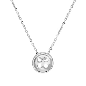May include: A silver necklace with a button pendant. The button has four holes and is suspended from a fine chain. A simple, elegant piece of jewellery.