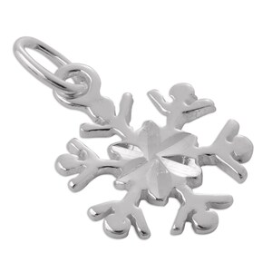 May include: A polished silver-toned snowflake pendant featuring a six-pointed star design at the center with intricate, branching arms. The charm includes a small circular jump ring at the top for attachment, showcasing a reflective metallic finish.