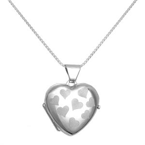 May include: A silver-toned heart-shaped locket pendant suspended from a delicate matching chain. The front surface of the locket features a polished finish with several matte-textured heart shapes etched into the metal across the front face.