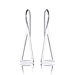 May include: A pair of silver-colored dangle earrings. Each earring features a triangular open frame suspended from a curved hook. The earrings are displayed against a white background, with their reflections visible below.
