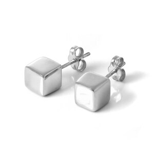 May include: A pair of silver cube stud earrings. Each earring has a small, polished, square design. The earrings are set against a white background, highlighting their reflective surfaces and simple, modern aesthetic.