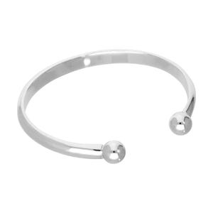 May include: A silver-coloured open cuff bracelet with a polished finish. The bracelet has a rounded design with a small ball at each open end. The jewellery is displayed against a white background.