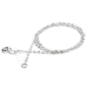 May include: A delicate silver necklace with a fine chain design. The necklace features a small clasp and an adjustable chain. The jewelry is displayed on a white background, highlighting its bright, reflective surface. The necklace is a simple, elegant accessory.