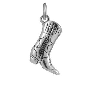 May include: A polished silver-tone metal charm shaped like a cowboy boot, featuring detailed stitching lines, a pointed toe, a defined heel, and a small circular jump ring attached at the top for hanging on a necklace or bracelet chain.