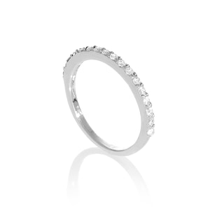 May include: A silver ring featuring a line of small, clear gemstones. The ring has a polished, reflective surface. The gemstones are set along the top of the band, creating a sparkling effect. The ring is a simple, elegant design.