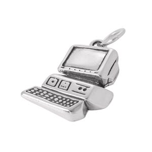 May include: A silver-toned metal charm shaped like a vintage desktop computer. The charm features a monitor, a keyboard with detailed keys, and a central processing unit with visible drive slots. A small jump ring is attached to the top for hanging.