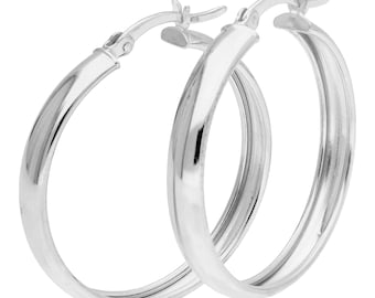 May include: A pair of polished silver hoop earrings. The earrings are circular with a smooth surface. The clasp is visible at the top of each earring. A classic jewellery design.