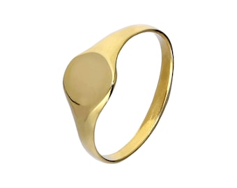 May include: A gold signet ring with a polished finish. The ring has a smooth, oval-shaped face and a simple, rounded band. The ring is a classic piece of jewellery.
