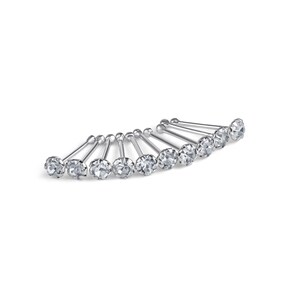 May include: A collection of silver nose studs, each with a clear, round gemstone. The studs are arranged in a semi-circular pattern against a white background, highlighting their sparkling facets. The metal posts are thin and straight.