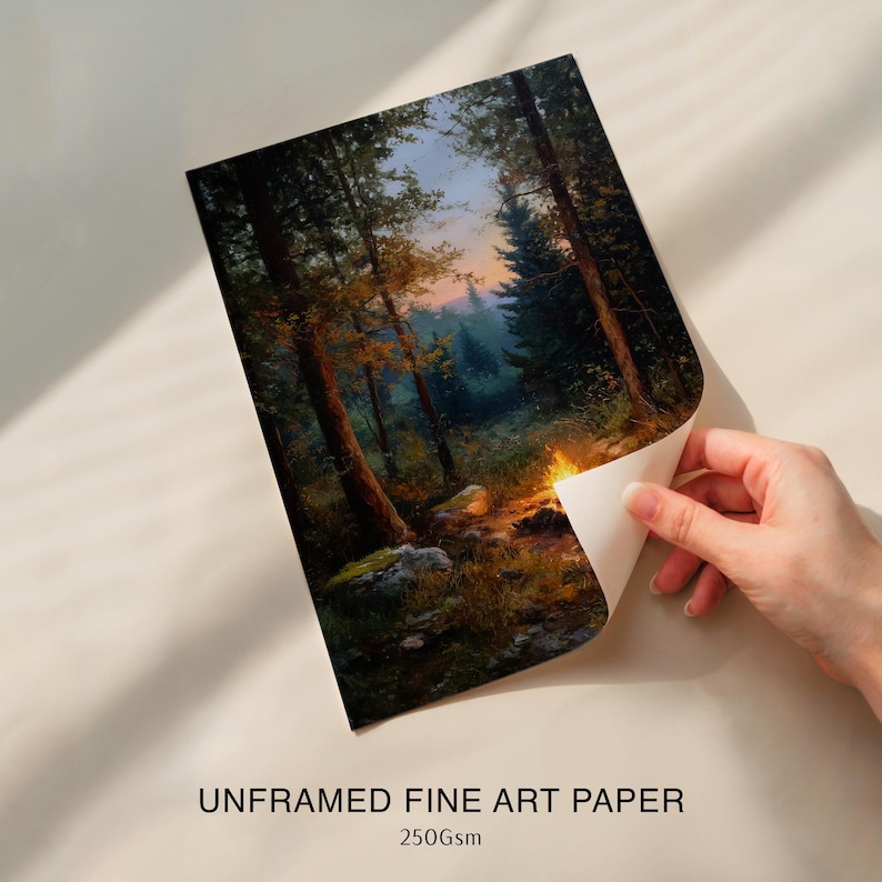 May include: Unframed fine art paper with a forest scene. The artwork depicts tall trees, a campfire, and a path leading into the distance. The paper is labeled "UNFRAMED FINE ART PAPER" and "250gsm".