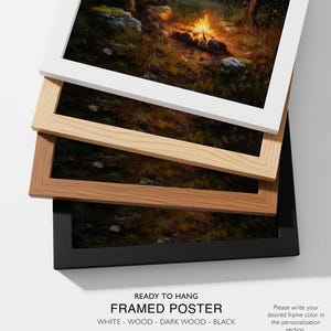May include: Framed poster with a forest scene, available in white, wood, dark wood, and black frames. The image shows a campfire in a forest. Text at the bottom reads "READY TO HANG FRAMED POSTER" and frame color options.