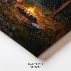 May include: Canvas art print depicting a campfire scene in a forest. The artwork features a vibrant campfire with orange and yellow flames, surrounded by rocks and greenery. The text "READY TO HANG CANVAS" is printed at the bottom.