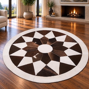 May include: A circular area rug featuring a geometric star pattern composed of alternating dark brown and white panels. The design includes a solid white centre circle, a starburst of dark brown and white points, and a wide white border edge.