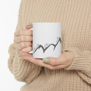 May include: White ceramic mug with a black mountain range design and the text "to the ends of the earth".