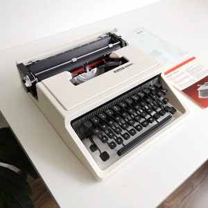 60% OFF!* Olivetti Dora typewriter, a portable vintage typewriter from the 1960s. In good condition with a case and manual