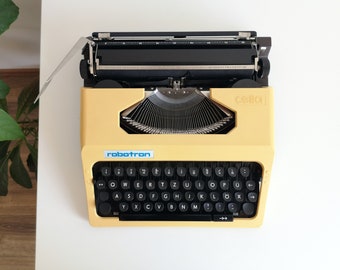 70 % RABATT! Robotron Cella, tragbare, funktionierende Vintage-Schreibmaschine aus den 1980er Jahren, in neuwertigem Zustand, mit Koffer und Originalverpackung, ungewöhnliches Geschenk
