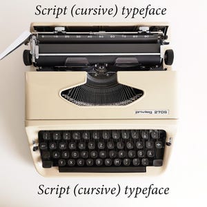 May include: Cream-colored vintage typewriter with black keys and the text "privileg 2708". The top is open, revealing the inner workings. The image includes the text "Script (cursive) typeface".