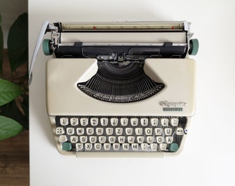 60% OFF!* Olympia Splendid 66 typewriter, a portable vintage typewriter from the 1960s. In very good condition, with a case