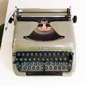 60% OFF!* Green-olive Erika Model 10 a portable working vintage typewriter from the 1950s. In awesome condition, with case, unusual gift