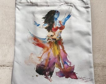 May include: A white tote bag featuring a watercolour painting of a dancer in a colourful skirt and top. The dancer is in mid-air with her arms outstretched.