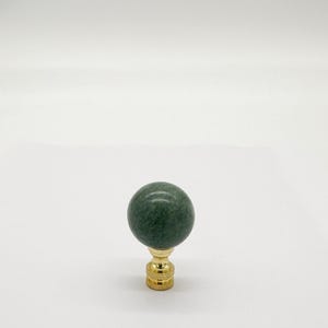 May include: A green marble lamp finial with a gold base.