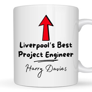May include: White ceramic mug with a red arrow pointing up and the text "Liverpool's Best Project Engineer Harry Davies".