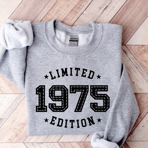 May include: Gray sweatshirt with black text that reads "Limited Edition 1975" in a vintage style font.