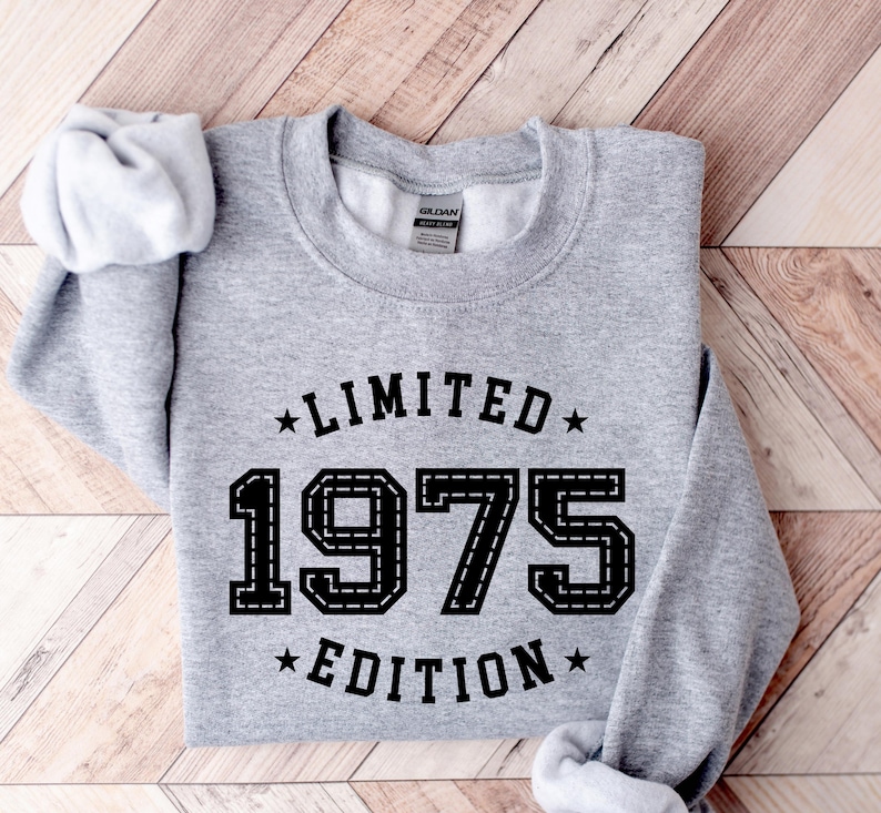 May include: Gray sweatshirt with black text that reads "Limited Edition 1975" in a vintage style font.