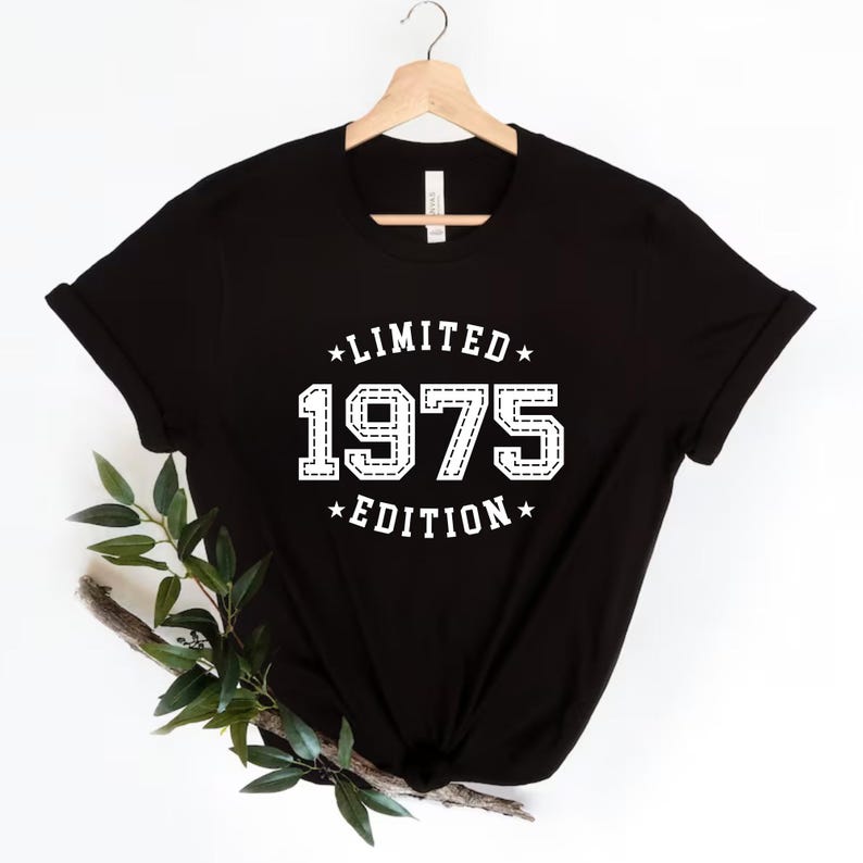 May include: Black t-shirt with white text that reads "*LIMITED* 1975 *EDITION*"
