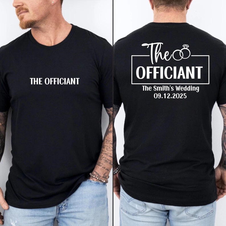 May include: Black t-shirt with white text that says "The Officiant" on the front and "The Officiant" with a ring design and "The Smith's Wedding 09.12.2025" on the back.