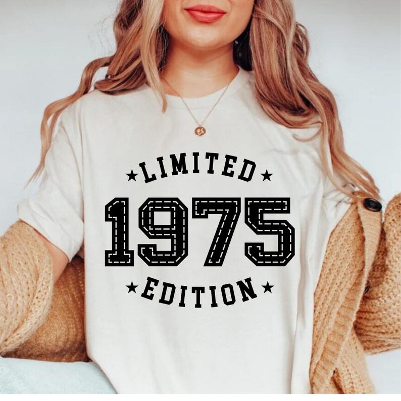 May include: White t-shirt with black text that reads "Limited 1975 Edition".