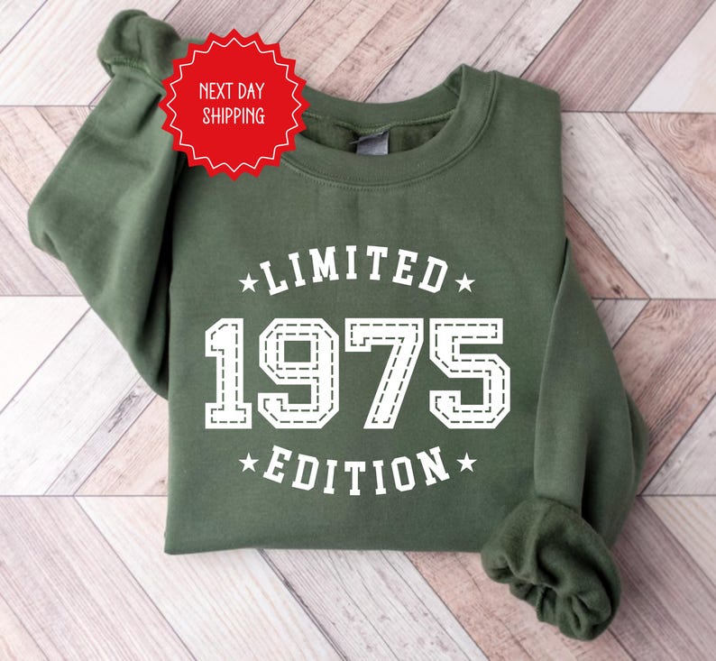May include: Green sweatshirt with white text that reads "Limited 1975 Edition".