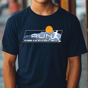 May include: Navy blue t-shirt with a white silhouette of a runner and the word "RUN" in white text. The design also includes a yellow sun and blue mountains. The text "With endurance run the race that is set before us Hebrews 12:1" is printed below the design.