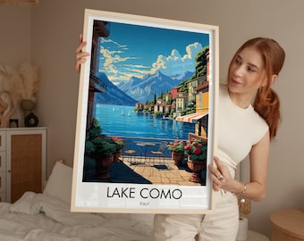 May include: A framed poster with a colorful illustration of Lake Como, Italy. The poster features a view of the lake with buildings and mountains in the background. The text "LAKE COMO" and "ITALY" is printed at the bottom of the poster.